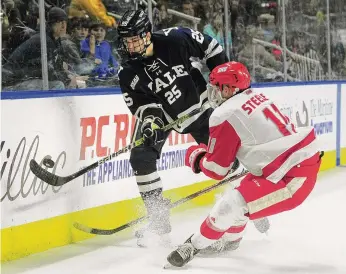  ?? ?? Yale’s Phil Kemp, left, passes the puck as Sacred Heart’s Ryan Steele converges during the 2020 Connecticu­t Ice Tournament. Kemp, who is from Greenwich, made his NHL debut for the Edmonton Oilers on Jan. 13.