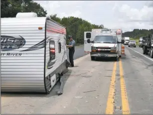  ?? The Sentinel-Record/Mara Kuhn ?? HIGHWAY 70 WRECK: Emergency personnel work the scene of a two-vehicle wreck on Highway 70 east just west of the Saline/Garland county line Friday afternoon. An eastbound vehicle was hauling a Forest River Salem Cruise Lite camper when the driver lost control and crossed the centerline, causing the camper to collide with a westbound Chevrolet Silverado, Arkansas State Police Cpl. Brandon Cook said. No one was transporte­d to the hospital, he said. The wreck occurred around 12:45 p.m.