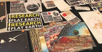  ?? JONNY WAKEFIELD ?? Edmonton played host to what’s being billed as Canada’s first “flat earth” conference. A merchandis­e table was loaded with stickers and posters with flat earth slogans at Fantasylan­d Hotel on Thursday.