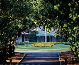  ?? CURTIS COMPTON / CCOMPTON@AJC.COM ?? Augusta National Golf Club is seen down Magnolia Lane appearing as well-manicured as usual on what would have been the first practice round for the Masters on Monday in Augusta. The golf club has identified Nov. 9-15 as the intended dates to host the 2020 Masters.