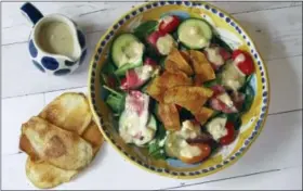  ?? SARA MOULTON VIA AP ?? This photo shows a warm steak and potato chip salad with blue cheese dressing in New York. This dish is from a recipe by Sara Moulton.