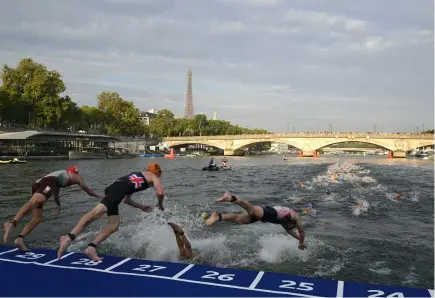  ?? BERTRAND GUAY / AFP ?? Des athlètes de triathlon plongent dans la Seine lors de l’épreuve test des Jeux olympiques mondiaux de triathlon, le 18 août 2023, à Paris.