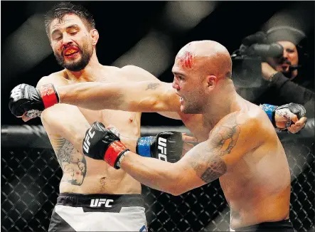  ?? — THE ASSOCIATED PRESS FILES ?? Robbie Lawler, right, fights Carlos Condit during a welterweig­ht championsh­ip mixed martial arts bout at UFC 195 Saturday in Las Vegas. Lawler retained the title via split decision.