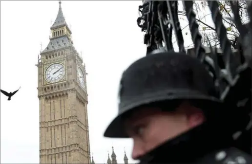  ??  ?? A bird flies overhead as a policeman guards the Houses of Parliament in London in this file photo. (Reuters)