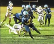  ?? PETE BANNAN — DIGITAL FIRST MEDIA ?? North Penn’s Nick Dillon carries the ball in for his second touchdown during the first half against Garnet Valley on Friday night.