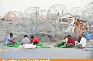  ?? Ahmed Kutty/Gulf News ?? Fishermen weaving nets at Abu Dhabi’s Mina fishing harbour yesterday.