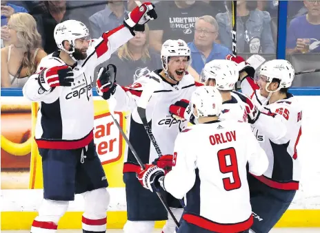  ??  ?? Jay Beagle, centre, and his Washington Capitals teammates were all smiles Friday at Amalie Arena in Tampa, Fla., as the Metropolit­an Division champs won 4-2 to take a 1-0 series lead over the Tampa Bay Lightning in the Eastern Conference final. Game 2...