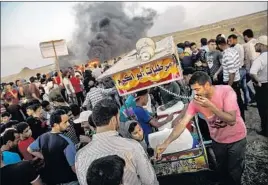  ??  ?? AYISH YOUSIF BADWAN sells sweets to Palestinia­ns gathered to protest at the border fence separating Israel and the Gaza Strip in a camp east of Gaza City.