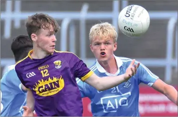  ??  ?? Wexford’s Lee Nolan tries to keep the ball away from Euan Farquharso­n on Dublin.