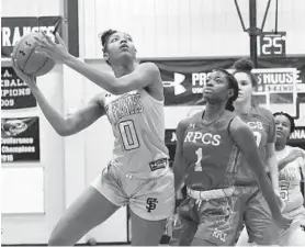  ?? KENNETH K. LAM/BALTIMORE SUN ?? St. Frances’ Angel Reese, left, goes up to shoot against Roland Park’s Mir McLean in the first half on Monday night.