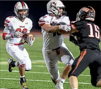  ?? Alexandra Wimley/Post-Gazette ?? Peters Township's Adrian Williams runs behind his blocking against Bethel Park Friday night at Bethel Park.