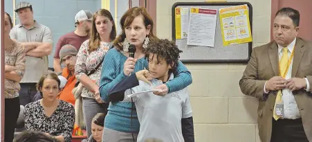  ?? STAFF PHOTOS BY CHRIS CHRISTO ?? ‘WHO’S GONNA PAY FOR IT?’: Parents of Boston Public Schools students, including Gretchen Lahey, above, speak out against new school start times at a meeting last night.