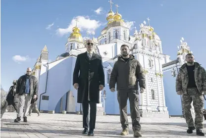  ?? EVAN VUCCI/AP ?? President Joe Biden walks with Ukrainian President Volodymyr Zelenskyy outside St. Michael’s gold-domed Cathedral on a surprise visit Monday to Kyiv. Moscow was notified before the trip “for deconflict­ion purposes.”