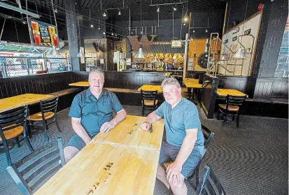  ?? JULIE JOCSAK TORSTAR ?? Mario Ciccarelli, owner of The Works, right, with Dave Brown at the downtown location. Ciccarelli fears many other restaurant­s will be shut down permanentl­y as new restrictio­ns are imposed.