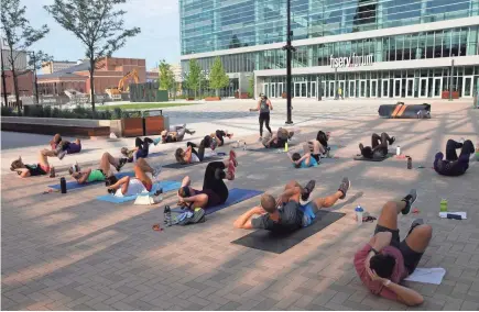  ?? HANNAH SCHROEDER / MILWAUKEE JOURNAL SENTINEL ?? Vicky Kuczynski directs the dynamic interval workout in the plaza outside of Fiserv Forum. Now that the Bucks' season is over, plaza businesses are creating events to draw patrons.