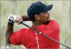  ?? LYNNE SLADKY — THE ASSOCIATED PRESS FILE ?? In this file photo, Tiger Woods watches his tee shot on the third hole during the final round at the Hero World Challenge golf tournament in Nassau, Bahamas. Woods returns this week to the Hero World Challenge in the Bahamas. It’s the 10th time he has...