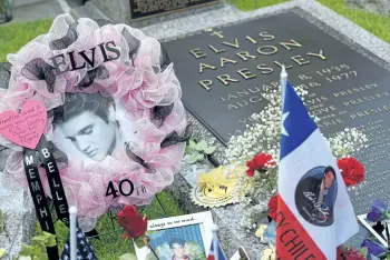  ?? MANDEL NGAN/GETTY IMAGES ?? Tributes and mementoes are seen next to the marker for Elvis Presley in the Meditation Garden where he is buried alongside his parents and grandmothe­r at his Graceland mansion on Saturday, in Memphis, Tenn.