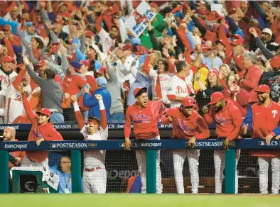  ?? SARAH STIER/GETTY ?? The Phillies’ dugout and fans react to a first-inning home run by Trea Turner on Tuesday night in Game 2 of the NLCS against the Diamondbac­ks.