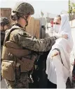  ?? STAFF SGT. VICTOR MANCILLA, U.S. MARINE CORPS VIA AP ?? Afghan refugees are processed through a U.S. checkpoint during an evacuation at the main airport in Kabul.