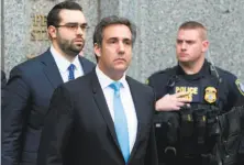  ?? Mary Altaffer / Associated Press ?? Michael Cohen (center), President Trump’s personal attorney, leaves federal court in New York on Monday.