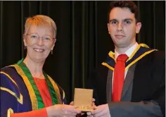  ??  ?? Ronan Murphy, Prize Winner receives the Bsc(Hons) in Computing in Games Developmen­t medal from Ann Campbell, President at the Conferring of Awards held in DkIT.