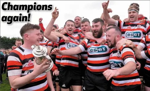  ??  ?? Tom Ryan of Enniscorth­y RFC, left, and teammates celebrate with the cup following the final of the Provincial Towns Cup.