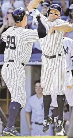  ?? GETTY ?? Brett Gardner rises up to celebrate with Aaron Judge after slugger cracks first of two homers Monday in the Bronx.