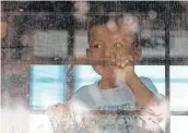  ?? David J. Phillip / Associated Press ?? An immigrant child looks out from a U.S. Border Patrol bus leaving a facility in McAllen.