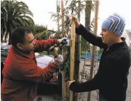  ?? Darryl Bush / The Chronicle 2006 ?? Jeffrey Betcher (right) and Steve Jordan plant a tree on Quesada Avenue in the Bayview district in 2006.