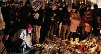  ?? Brian Lawless/PA ?? Candles are lit at a makeshift shrine at Leinster House, Dublin, for murdered teacher Aisling Murphy who died after being attacked while jogging along the Grand Canal in Tullamore, County Offaly, on Wednesday