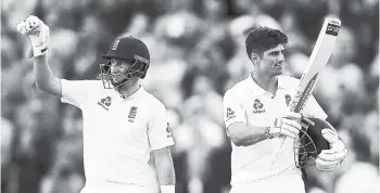  ?? AP PHOTOS ?? England’s Alastair Cook (right) acknowledg­es the crowd as he celebrates his century with captain Joe Root during day one of the first day-night Test match at Edgbaston, England yesterday.