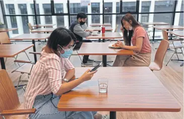  ?? VARUTH HIRUNYATHE­B ?? Employees practise social distancing at Sansiri headquarte­rs. Attempting to weather the Covid-19 downturn requires the right tools to become an agile organisati­on.