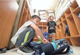  ?? DAN POWERS/USA TODAY NETWORK-WISCONSIN ?? Kindergart­en student Nic Xiong empties his backpack during the first day of school at Edison Elementary School in 2022 in Appleton.