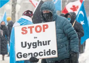  ?? ADRIAN WYLD THE CANADIAN PRESS ?? Protesters gather outside the Parliament buildings in Ottawa on Monday, when the House of Commons supported a motion declaring as genocide the atrocities committed against Uighurs in China’s autonomous region of Xinjiang.
