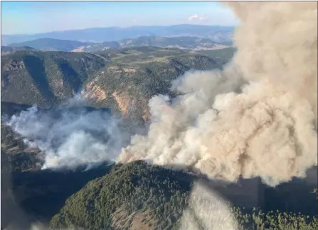  ?? The Canadian Press ?? The Keremeos Creek wildfire is shown burning north of Keremeos, B.C. The BC Wildfire Service says a fire burning about 21 kilometres southwest of Penticton saw minimal growth overnight Sunday but low visibility is making it difficult to fight from the air.