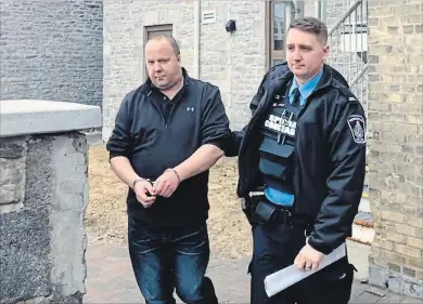  ?? TODD VANDONK METROLAND ?? Danny Eadie is escorted from the Peterborou­gh's Superior Court building after being sentenced to two years and eight months for driving into a woman and seriously injuring her in 2015.