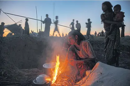  ??  ?? LEFT Rohingya in a temporary camp outside of Sittwe, the capital of Rakhine State.