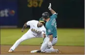  ?? JEFF CHIU — THE ASSOCIATED PRESS ?? The Seattle Mariners’ Kyle Seager, right, is tagged out by A’s shortstop Elvis Andrus trying to advance to second base on an RBI single during the fifth inning Monday in Oakland.