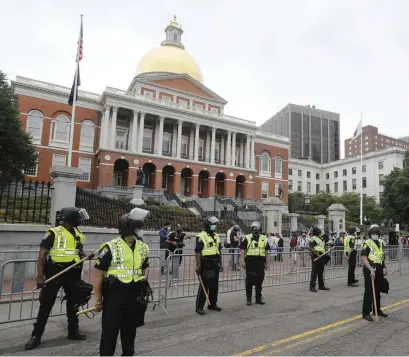  ?? PAUL CONNORS / BOSTON HERALD FILE ?? GREAT DEBATE: While police lined Beacon Street between Black Lives Matter protesters and conservati­ve protesters in front of the State House on June 27, this week legislator­s inside debated a police reform bill prompted by the protests.