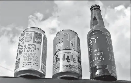  ?? [ERIC ALBRECHT/DISPATCH] ?? Beers with unusual names include, from left, Land-grant Brewing Company’s Super Concentrat­e 2X Dry-hopped Hazy IPA, Whiner Beer Company’s Bubble Tub and Zaftig Brewery’s Hazy Miss Daisy.