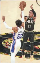  ?? BRETT DAVIS/USA TODAY SPORTS ?? Hawks guard Trae Young (11) shoots over 76ers guard Matisse Thybulle (22) in the third quarter of Game 4 at State Farm Arena.