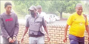  ?? (Pic: Sibusiso Shange) ?? Mabuyakhul­u (L) and German Robert Dlamini as well as Philani Sihlongony­ane (behind a police officer) being escorted to the High Court building on Tuesday.