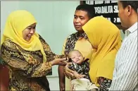  ?? CHANDRA SATWIKA/JAWA POS ?? PEROLEH KASIH SAYANG: Khofifah Indar Parawansa menyerahka­n Muh. Rafardhan kepada calon orang tua asuh Imbang Sutrisno dan Tita Pramita di PSAB Sidoarjo kemarin. Foto kanan, petugas PSAB bersama anak-anak yang akan diadopsi.