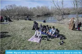  ??  ?? EDIRNE: Migrants pray near Edirne, Turkey, before taking a boat to attempt to cross the Meritsa river to enter Greece yesterday. —AFP