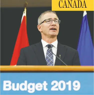  ?? IAN KUCERAK / POSTMEDIA FILES ?? Alberta Finance Minister Travis Toews speaks Thursday about Budget 2019, the United Conservati­ve Party’s
first, which will see the eliminatio­n of bureaucrat­ic jobs and cuts to spending to head off a “fiscal crisis.”