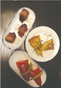  ?? JENNIFER BARDONER PHOTO ?? Tuna-stuffed piquillo peppers, bacon-wrapped dates and potato tortilla, clockwise from bottom.