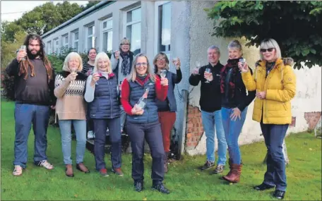  ?? 01_B12pirnmil­l02 ?? Pirnmill villagers celebrate taking over the ownership of Pirnmill Community Centre last year.