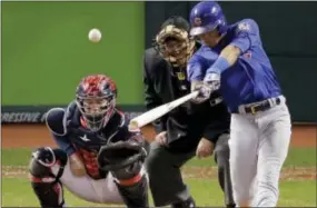  ?? CHARLIE RIEDEL — THE ASSOCIATED PRESS ?? The Cubs’ Addison Russell hits a grand slam against the Indians in the third inning of Game 6 Tuesday in Cleveland.