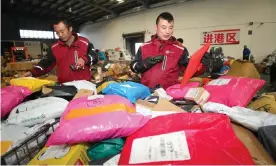  ??  ?? Staff at a logistics center categorize packages for Singles Day, a shopping holiday founded by Alibaba and popular among young Chinese people, in Lianyungan­g city, China. Photograph: Imaginechi­na/Rex/Shuttersto­ck