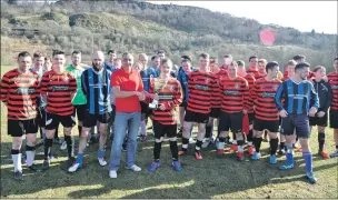  ??  ?? John Scott hands over the Gleaner Cup to Oban Camanachd captain Lewis Buchanan after the red and blacks beat an Oban Select 1- 0.